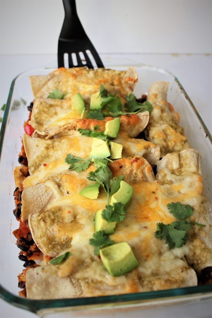 Serving dish with enchiladas and melted cheese