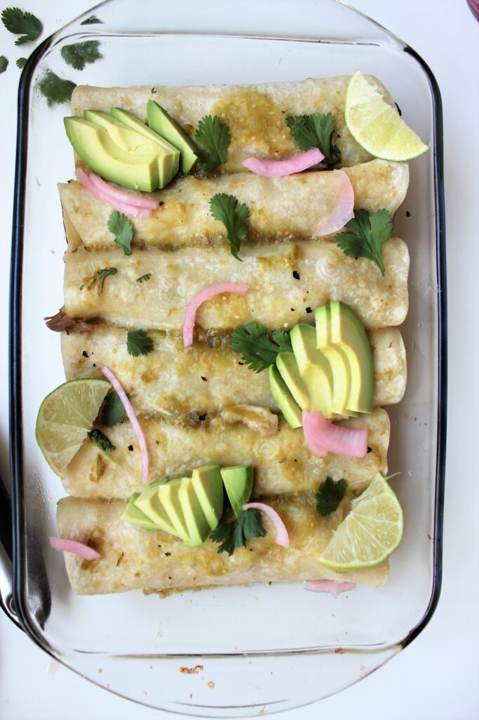 Dairy Free Chicken Enchiladas with avocados, pickles onions, and cilantro birds eye view