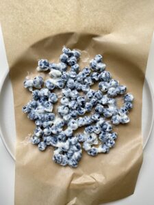 Frozen Yogurt Covered Blueberries on parchment paper birds eye view