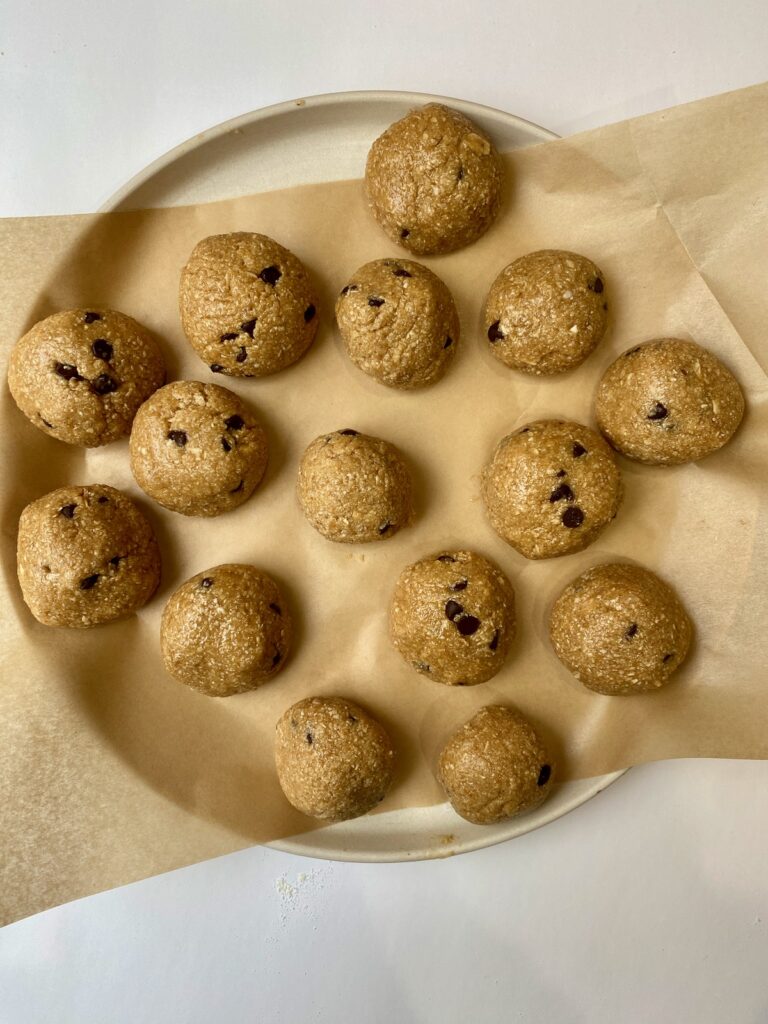 Plate full of chocolate chip cookie dough protein balls