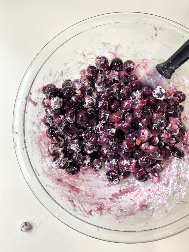 blueberries covered in corn starch in a glass mixing bowl